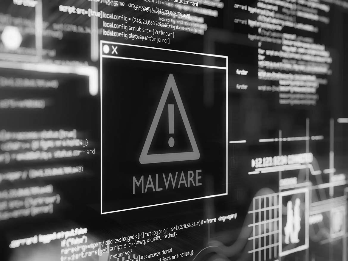 A digital screen displays a warning triangle with an exclamation mark and the word MALWARE in bold, surrounded by glowing lines and computer code, representing a cybersecurity threat and risk of data breaches.